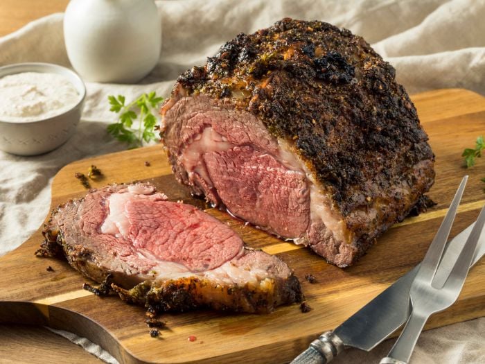 A perfectly smoked prime rib on a cutting board.